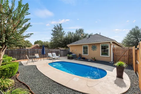 a view of a house with backyard and sitting area