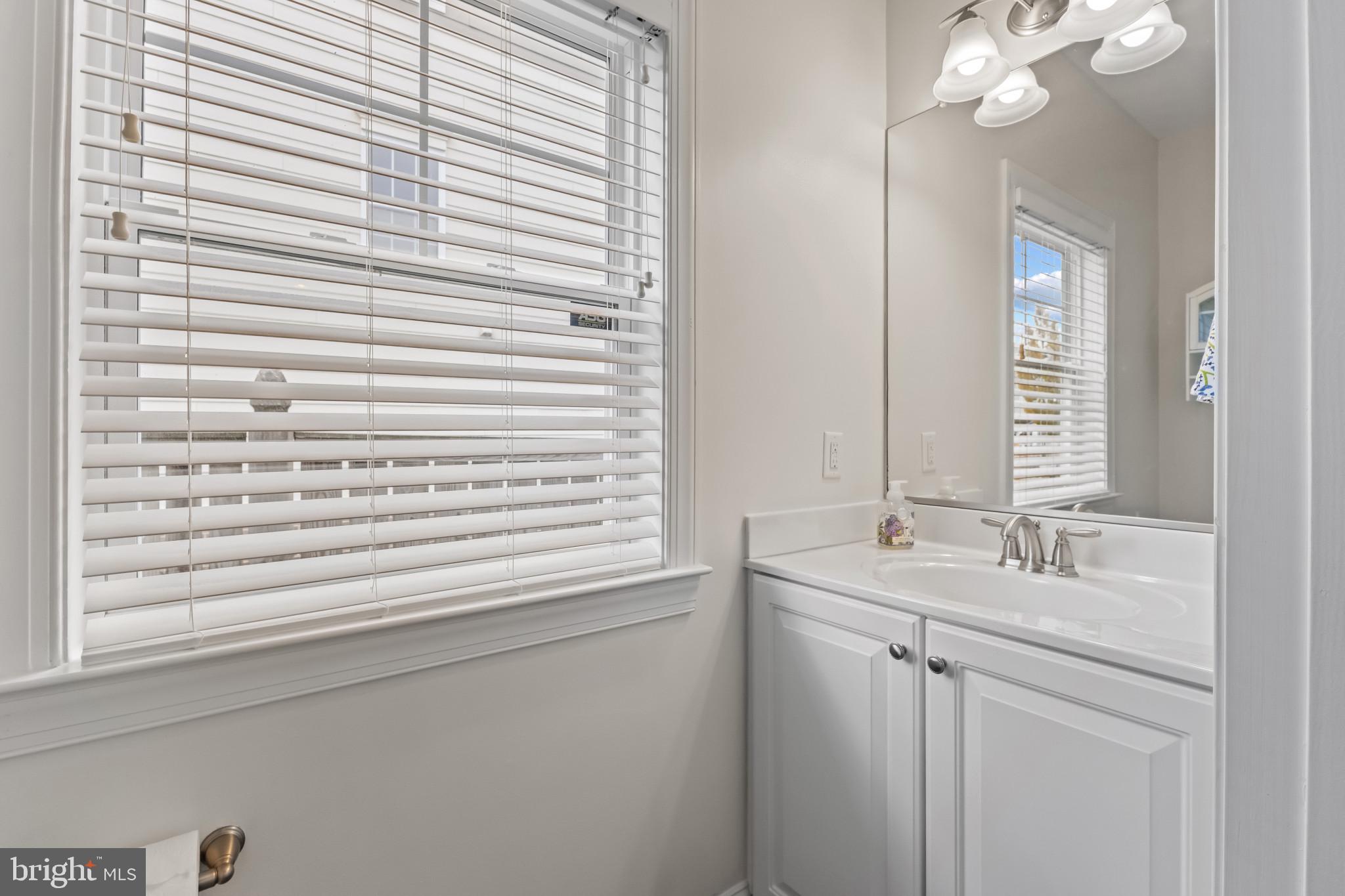 132 Claiborne Street Chester, MD 21619 - Photo 13 of 40 a bathroom with a sink and a mirror