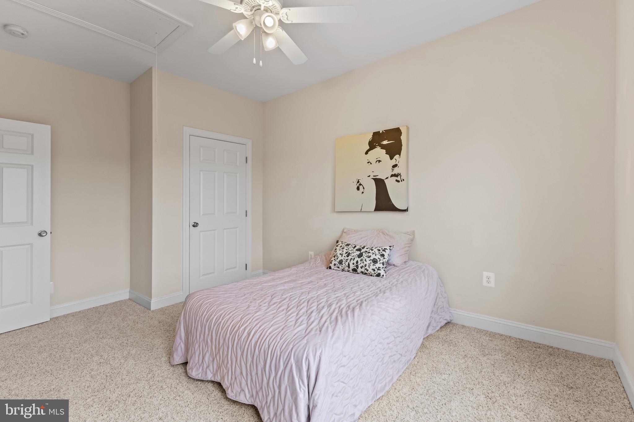 132 Claiborne Street Chester, MD 21619 - Photo 19 of 40 a bedroom with a bed and a chandelier