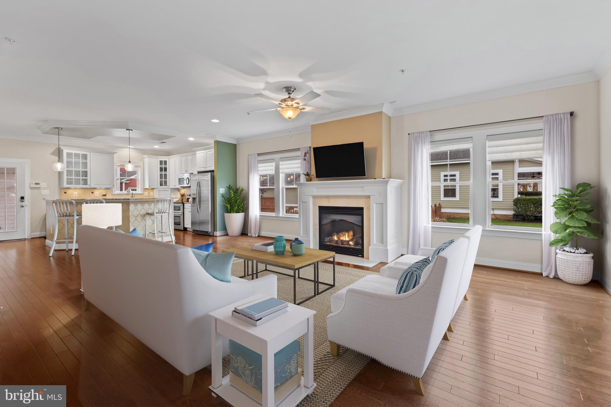 132 Claiborne Street Chester, MD 21619 - Photo 2 of 40 a living room with furniture a fireplace and a flat screen tv