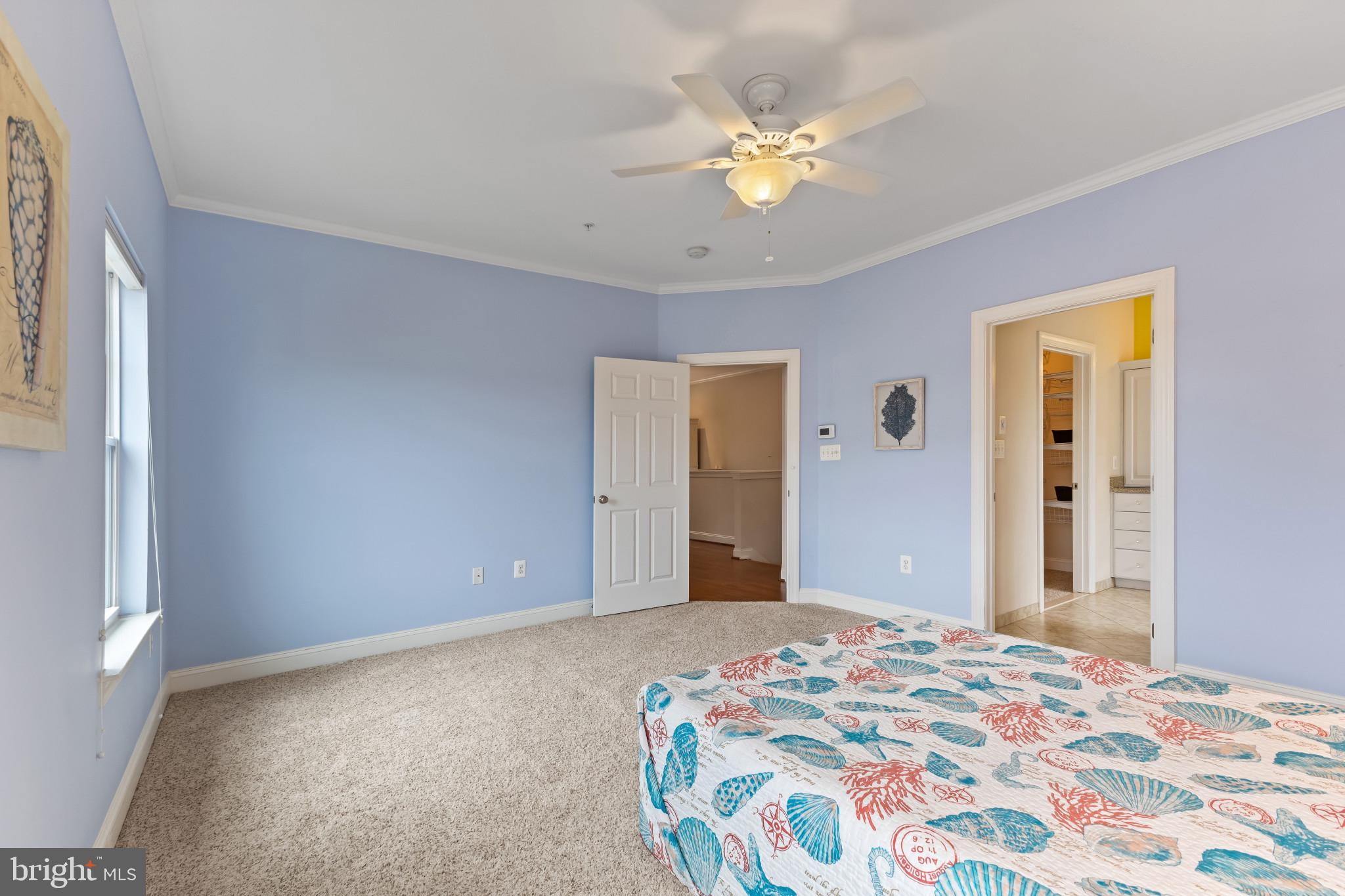 132 Claiborne Street Chester, MD 21619 - Photo 22 of 40 a bedroom with a bed and a chandelier