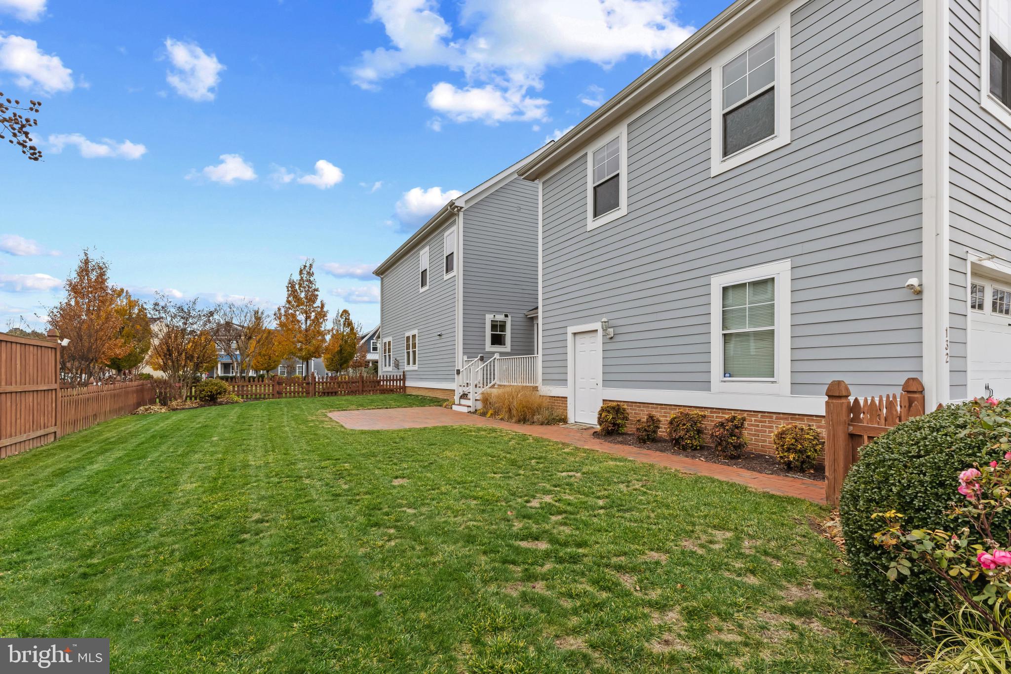 132 Claiborne Street Chester, MD 21619 - Photo 32 of 40 a backyard of a house with table and chairs plants and large tree