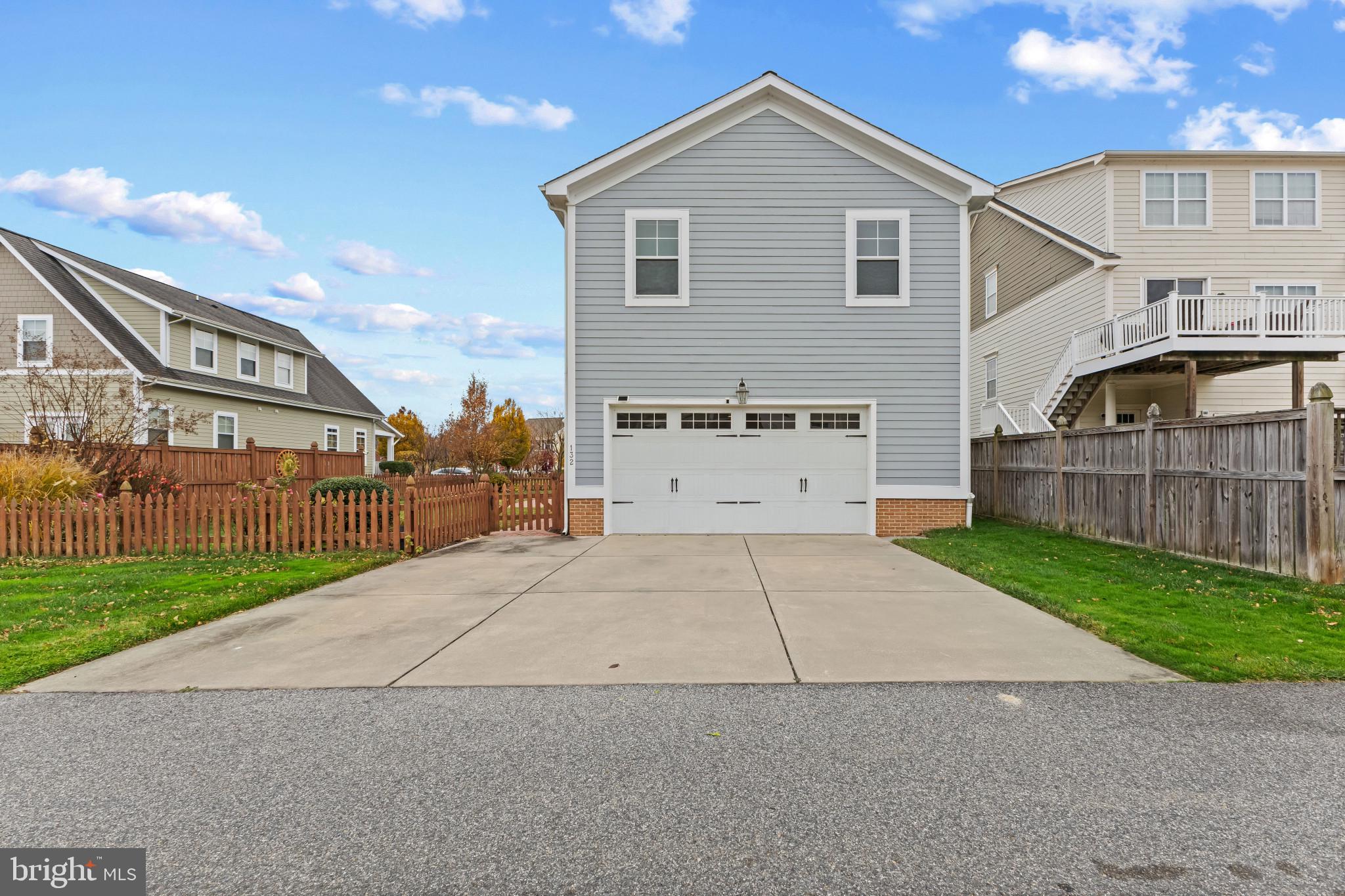 132 Claiborne Street Chester, MD 21619 - Photo 34 of 40 a front view of a house with a yard and garage