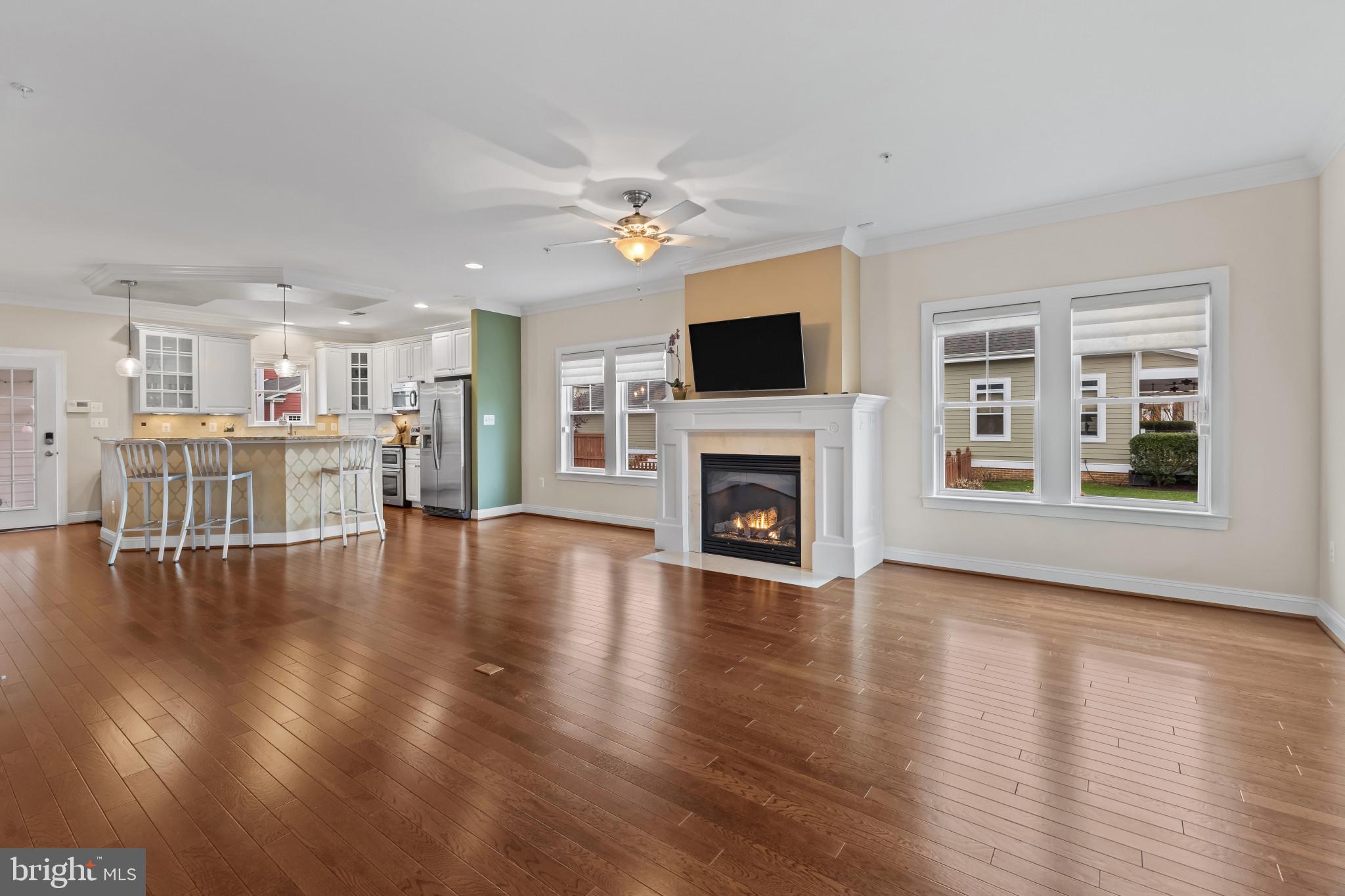 132 Claiborne Street Chester, MD 21619 - Photo 7 of 40 a view of a livingroom with wooden floor and a fireplace