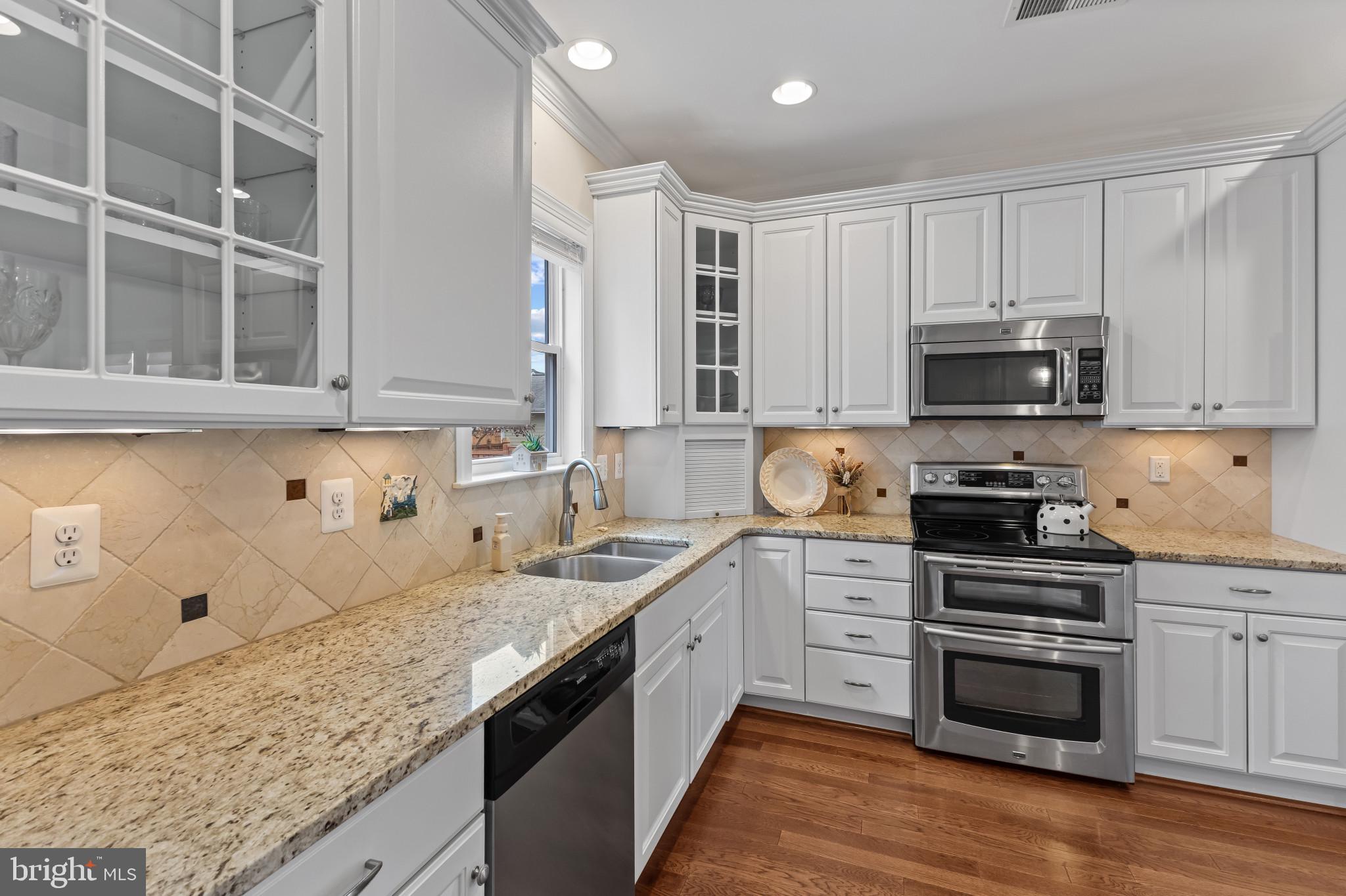 132 Claiborne Street Chester, MD 21619 - Photo 10 of 40 a kitchen with stainless steel appliances granite countertop a stove and a sink