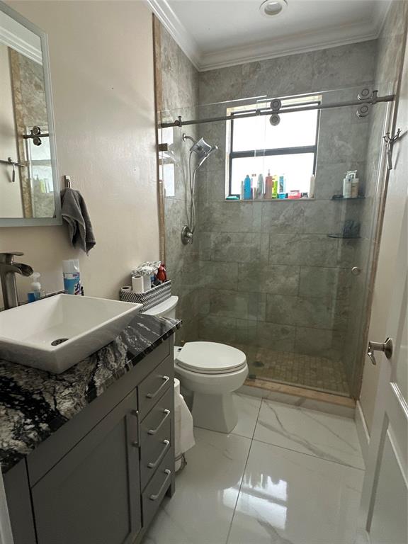 3401 Sand Road Cape Coral, FL 33993 - Photo 18 of 27 a bathroom with a granite countertop sink a toilet and shower