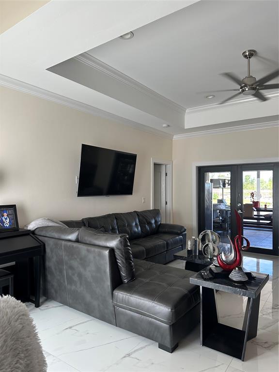 3401 Sand Road Cape Coral, FL 33993 - Photo 20 of 27 a living room with furniture and a flat screen tv