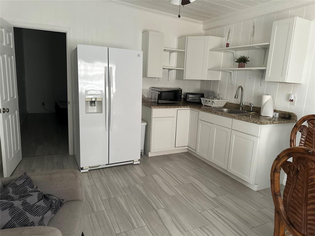 3401 Sand Road Cape Coral, FL 33993 - Photo 23 of 27 a kitchen with stainless steel appliances a refrigerator sink and cabinets