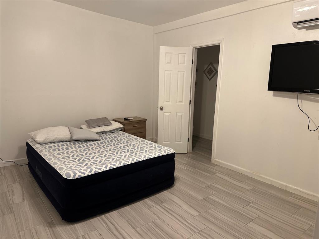 3401 Sand Road Cape Coral, FL 33993 - Photo 24 of 27 a room with a bed and a flat screen tv