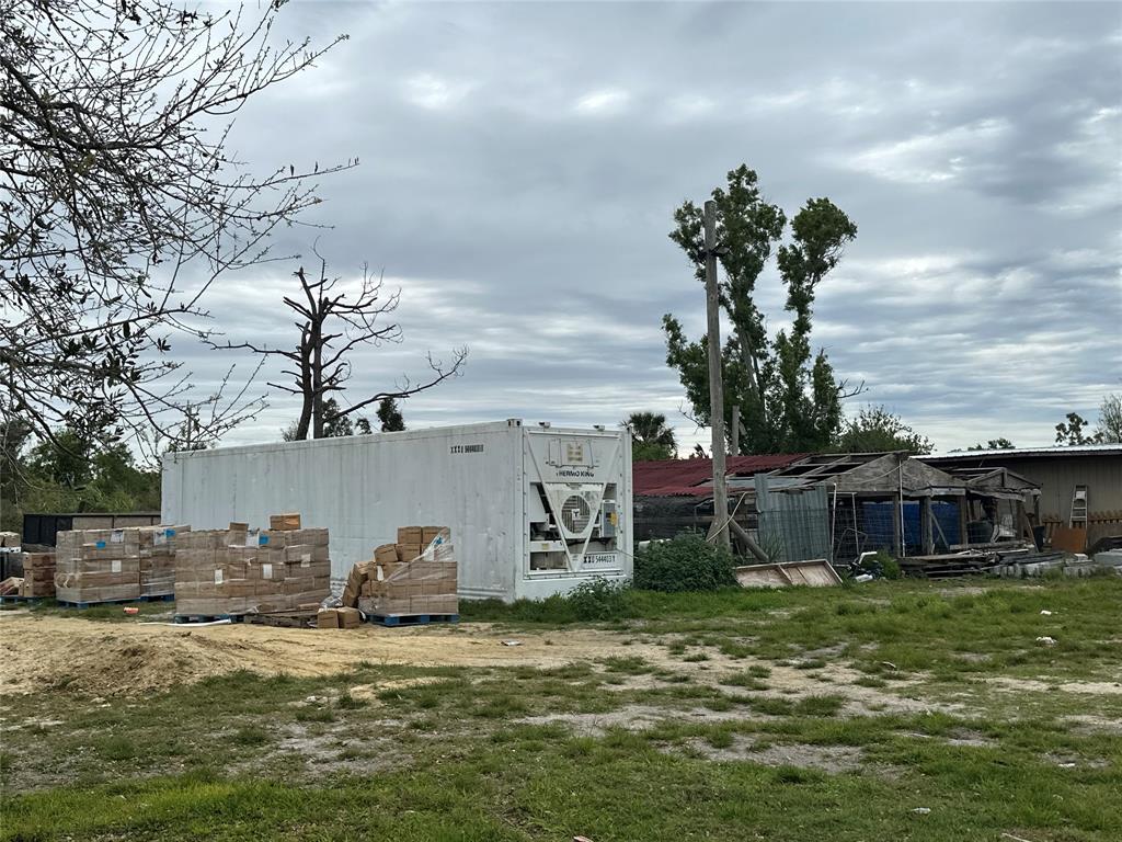 3401 Sand Road Cape Coral, FL 33993 - Photo 6 of 27 a front view of a house with a yard and potted plants
