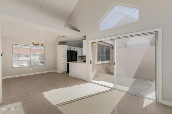 a view of kitchen with refrigerator and window
