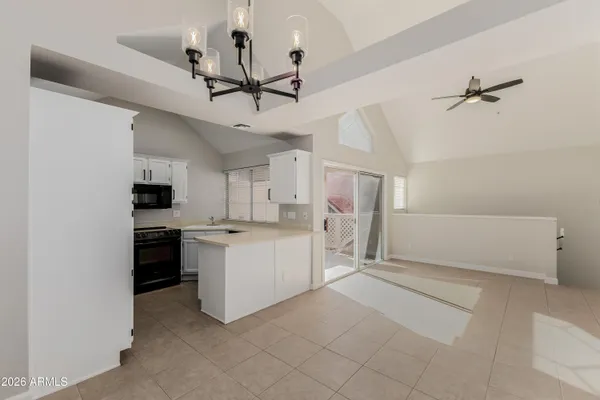 a view of a kitchen with microwave and a ceiling fan