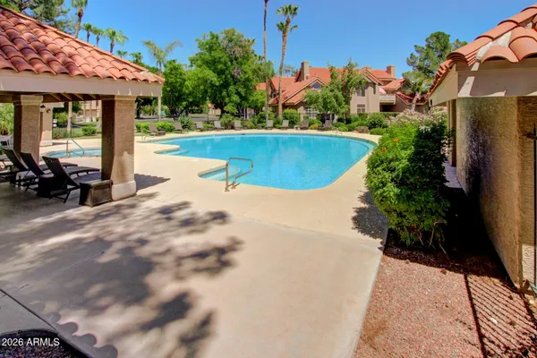 a view of a house with a yard and sitting area
