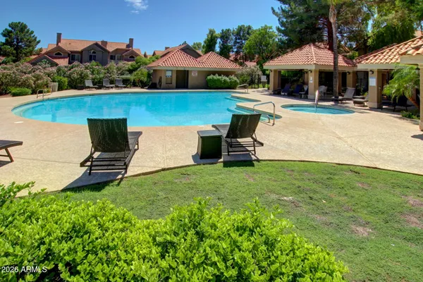 a view of yard with swimming pool and green space