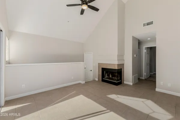 a view of a livingroom with a fireplace and window