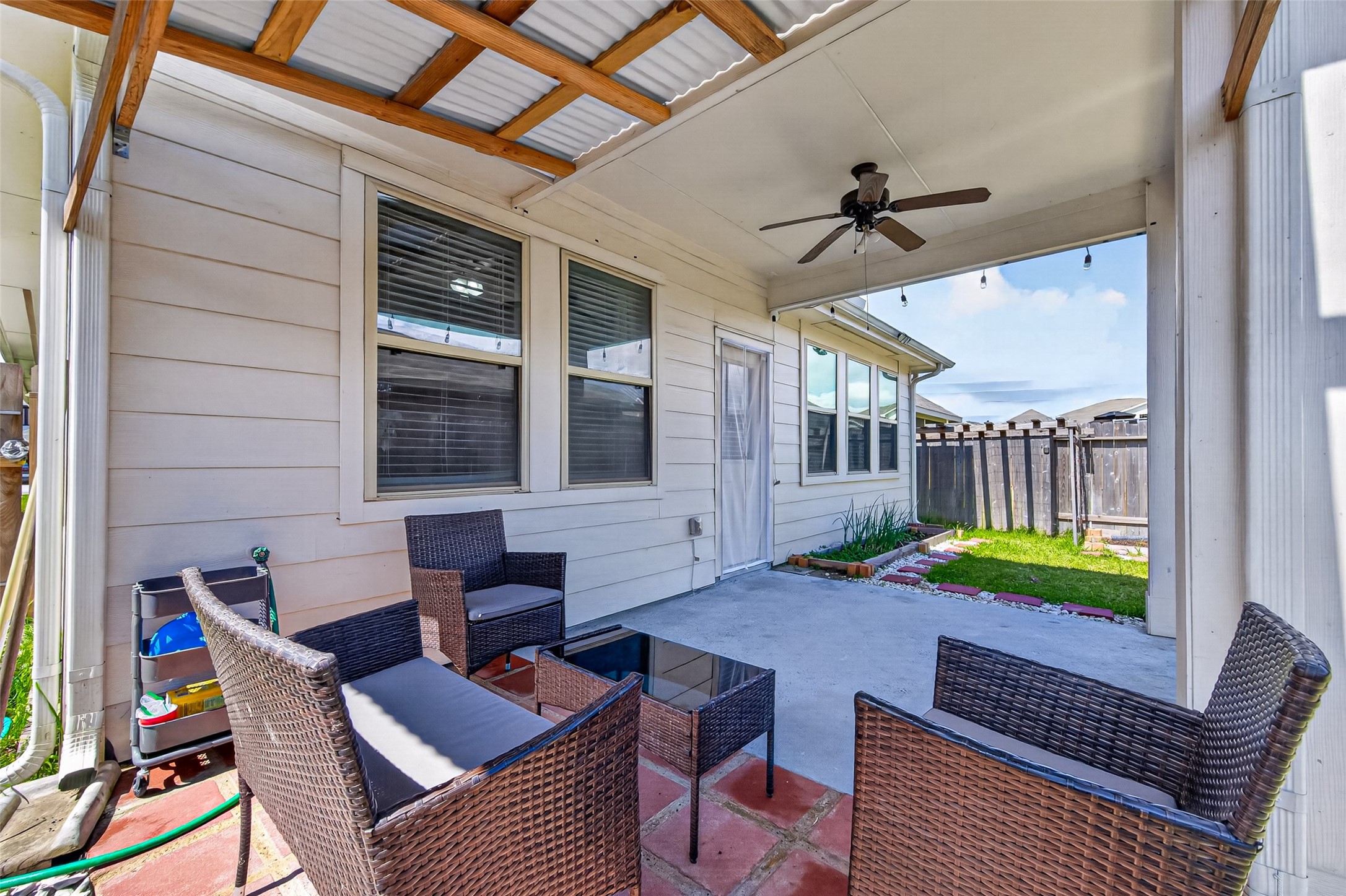22409 Kinley Street New Caney, TX 77357 - Photo 44 of 46 a backyard of a house with barbeque oven table and chairs