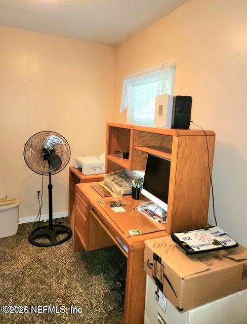 6107 Carlton Road Jacksonville, FL 32244 - Photo 23 of 39 a work room with furniture and a flat screen tv