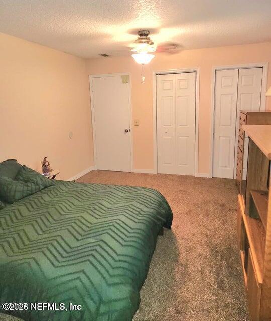 6107 Carlton Road Jacksonville, FL 32244 - Photo 27 of 39 a bedroom with a bed and a chandelier