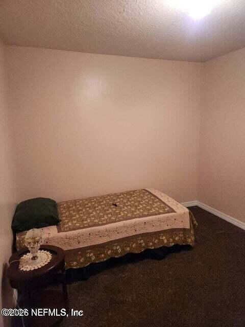 6107 Carlton Road Jacksonville, FL 32244 - Photo 31 of 39 a bed sitting in a bedroom next to a window