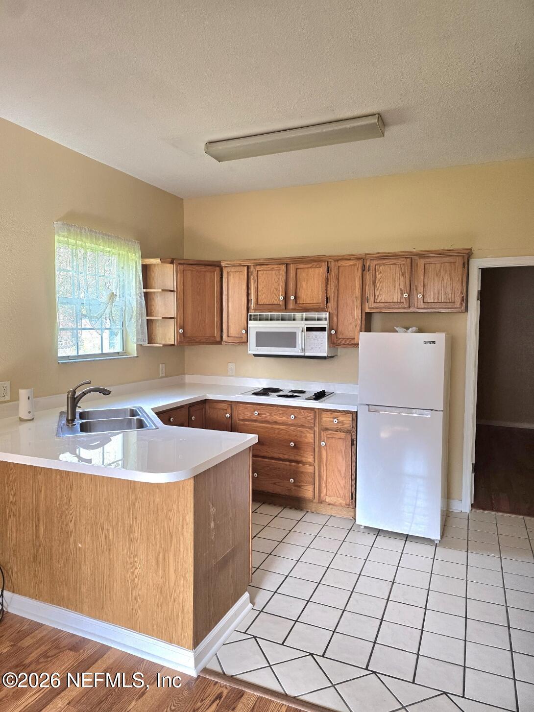 6107 Carlton Road Jacksonville, FL 32244 - Photo 35 of 39 a kitchen with stainless steel appliances granite countertop a sink stove and refrigerator