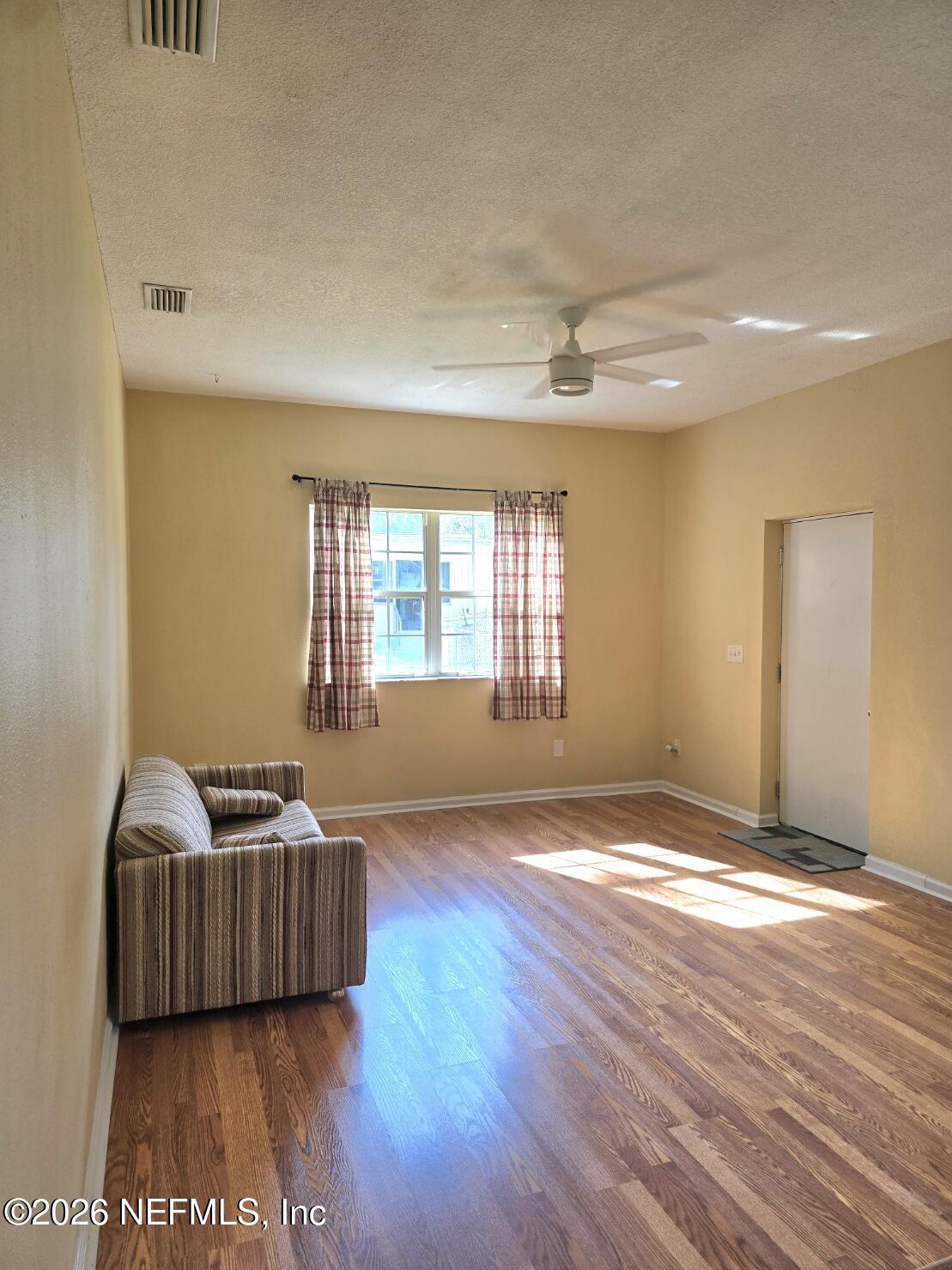 6107 Carlton Road Jacksonville, FL 32244 - Photo 36 of 39 a living room with a couch and a window