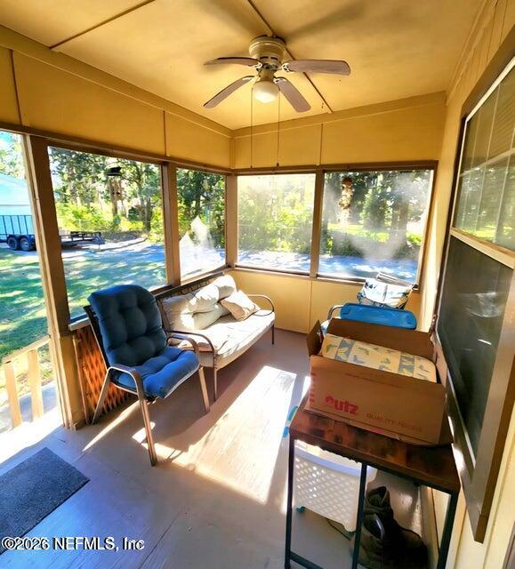 6107 Carlton Road Jacksonville, FL 32244 - Photo 8 of 39 a living room with furniture and a floor to ceiling window