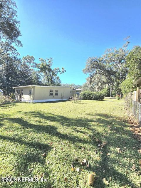 6107 Carlton Road Jacksonville, FL 32244 - Photo 9 of 39 a swimming pool with outdoor seating and yard