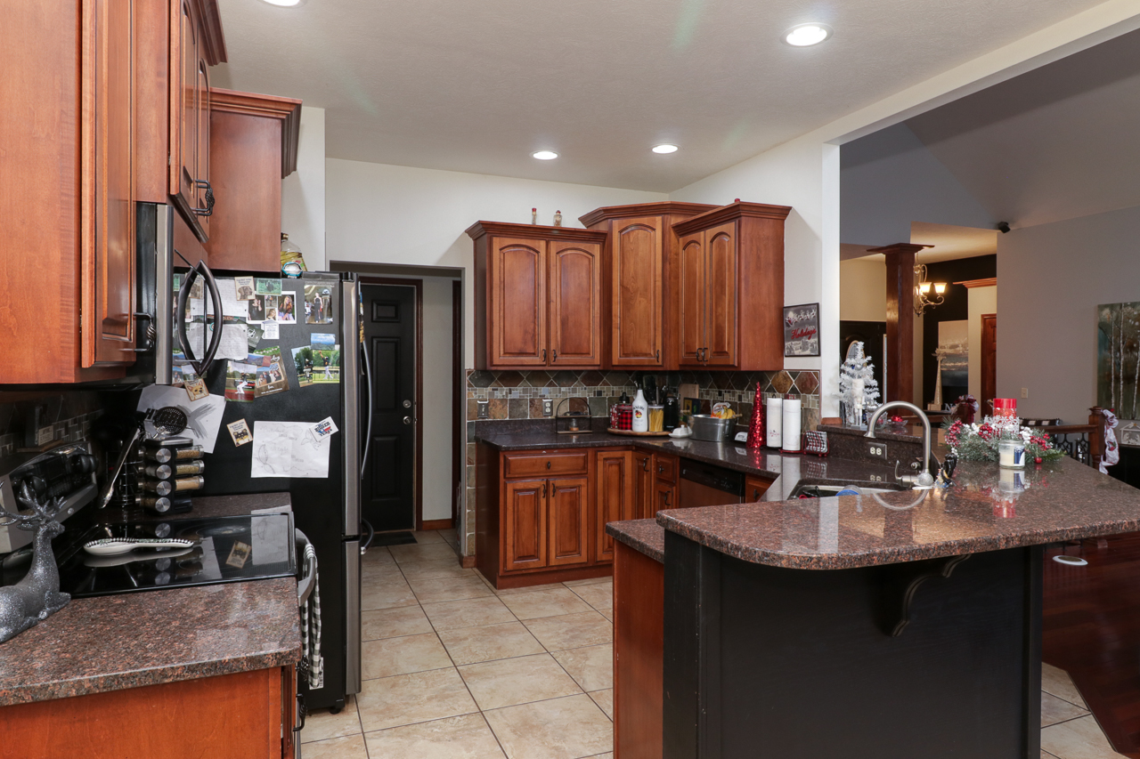 938 Kickapoo Drive Danvers, IL 61732 - Photo 14 of 49 a kitchen with kitchen island granite countertop a sink cabinets and stainless steel appliances