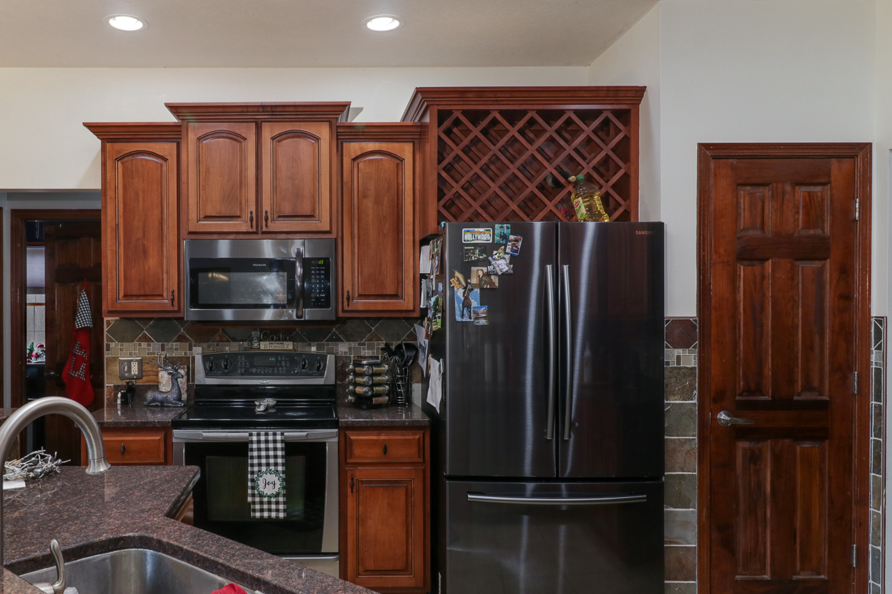938 Kickapoo Drive Danvers, IL 61732 - Photo 16 of 49 a kitchen with stainless steel appliances granite countertop a refrigerator and a sink