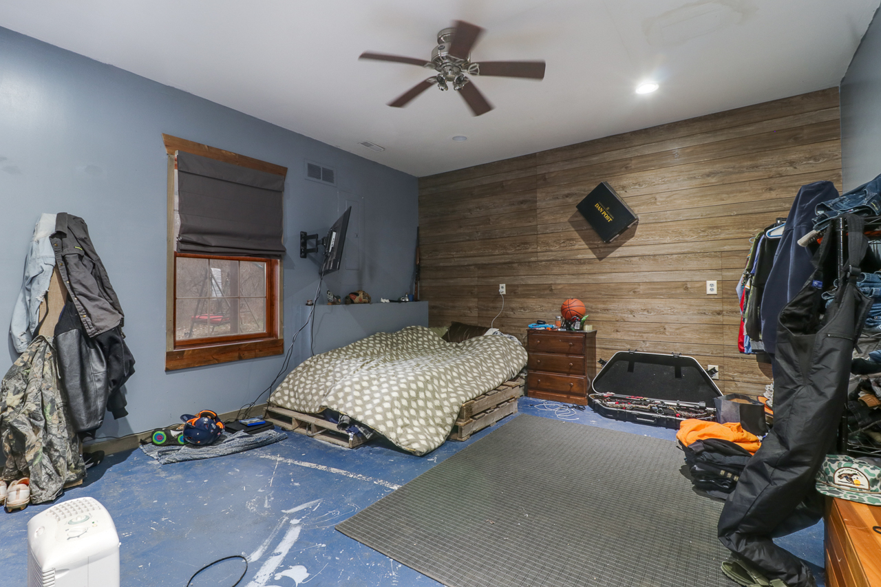 938 Kickapoo Drive Danvers, IL 61732 - Photo 26 of 49 a bedroom with bed and a chandelier