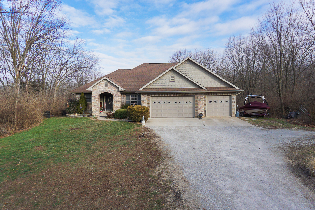 938 Kickapoo Drive Danvers, IL 61732 - Photo 34 of 49 a front view of a house with a yard and garage