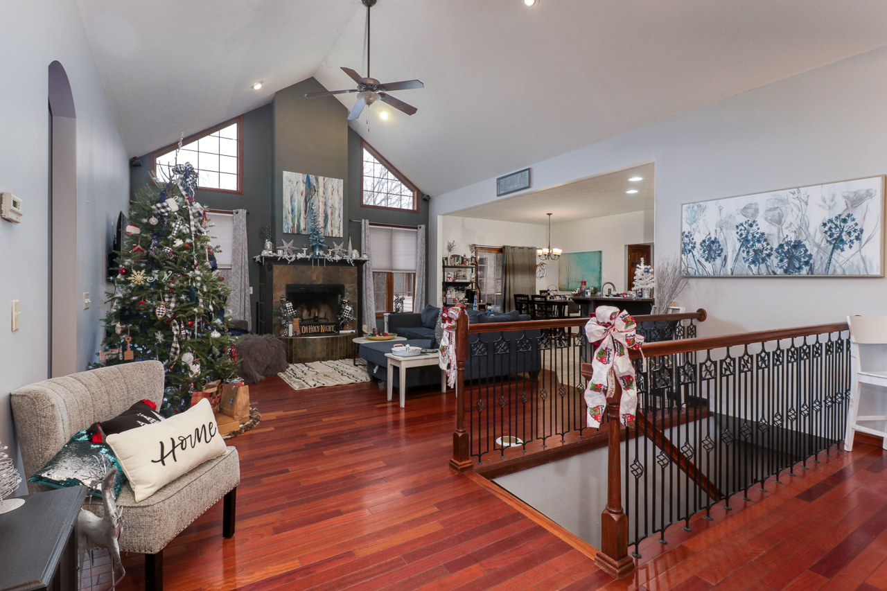 938 Kickapoo Drive Danvers, IL 61732 - Photo 5 of 49 a living room with furniture a fireplace and a chandelier