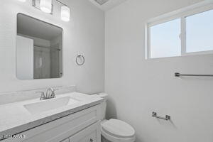 15601 North 22nd Street Phoenix, AZ 85022 - Photo 19 of 27 a bathroom with a granite countertop toilet sink and mirror
