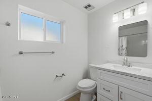 15601 North 22nd Street Phoenix, AZ 85022 - Photo 22 of 27 a bathroom with a sink toilet and mirror