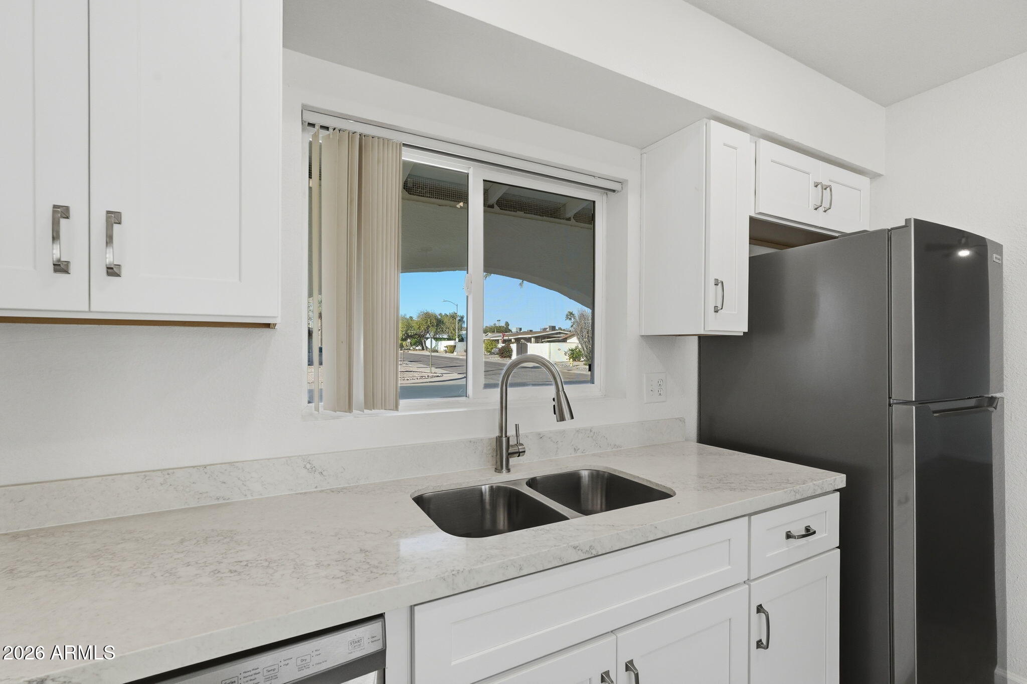15601 North 22nd Street Phoenix, AZ 85022 - Photo 8 of 27 a kitchen with stainless steel appliances a sink and a refrigerator