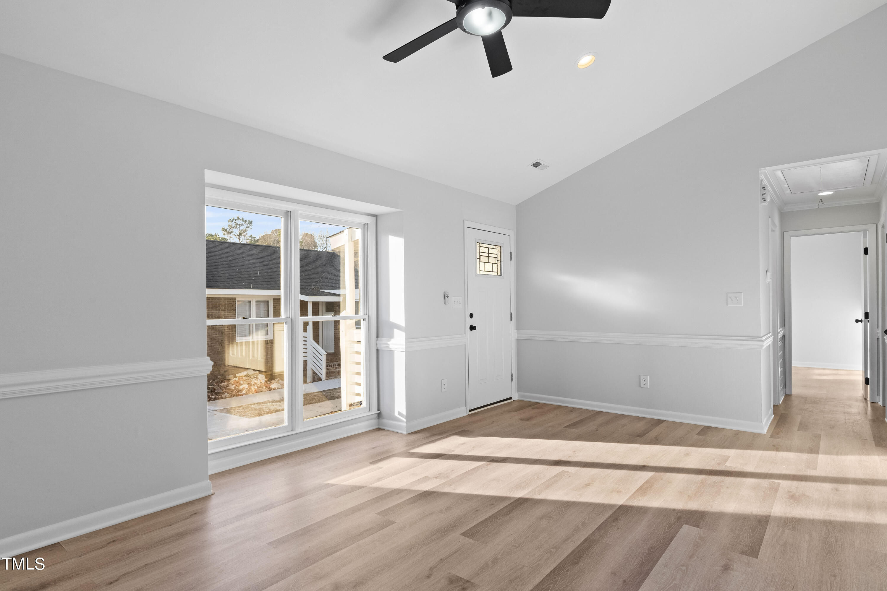 4704 Courtside Place Raleigh, NC 27604 - Photo 12 of 33 a view of an empty room with wooden floor and a window
