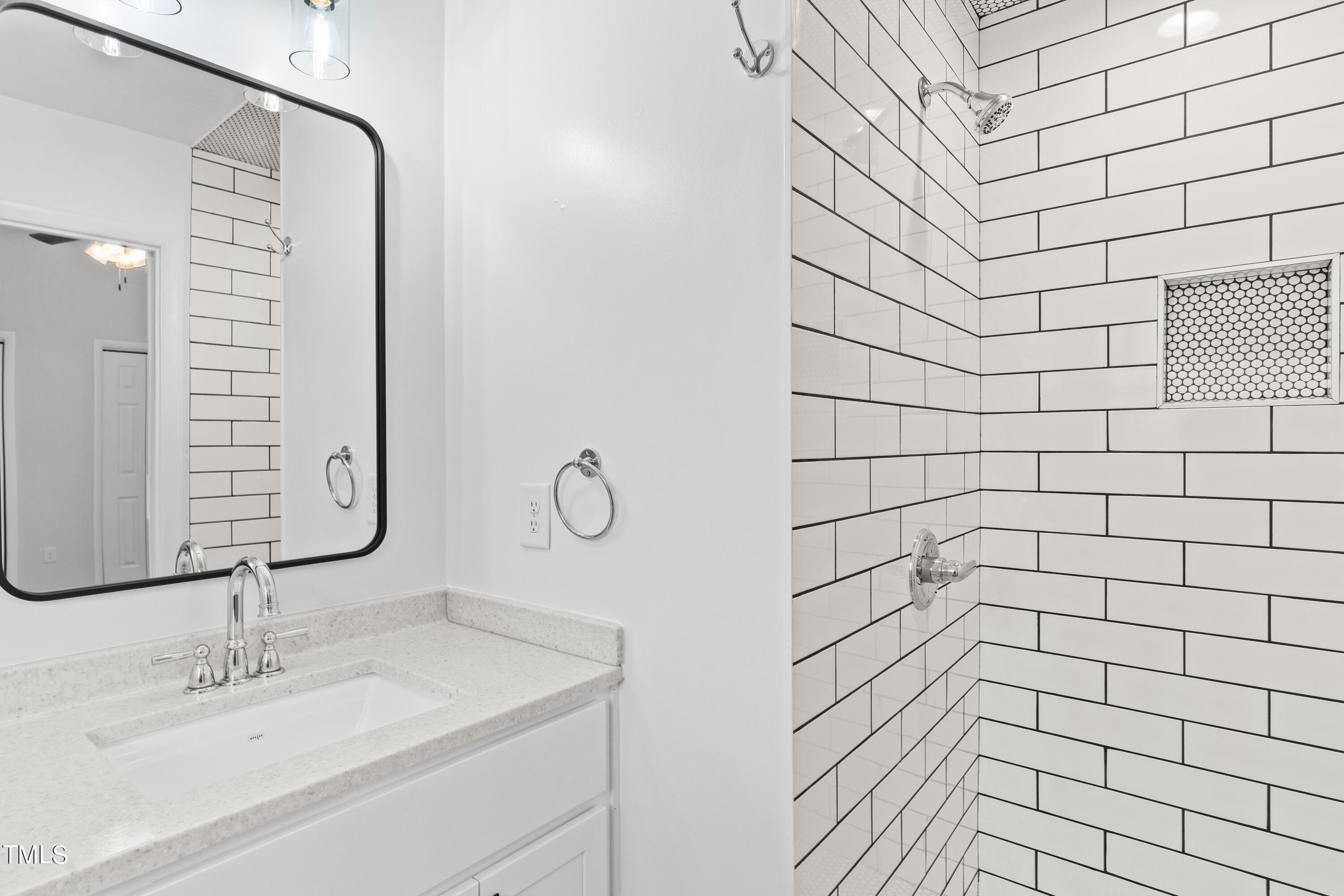 4704 Courtside Place Raleigh, NC 27604 - Photo 22 of 33 a bathroom with a sink and a mirror
