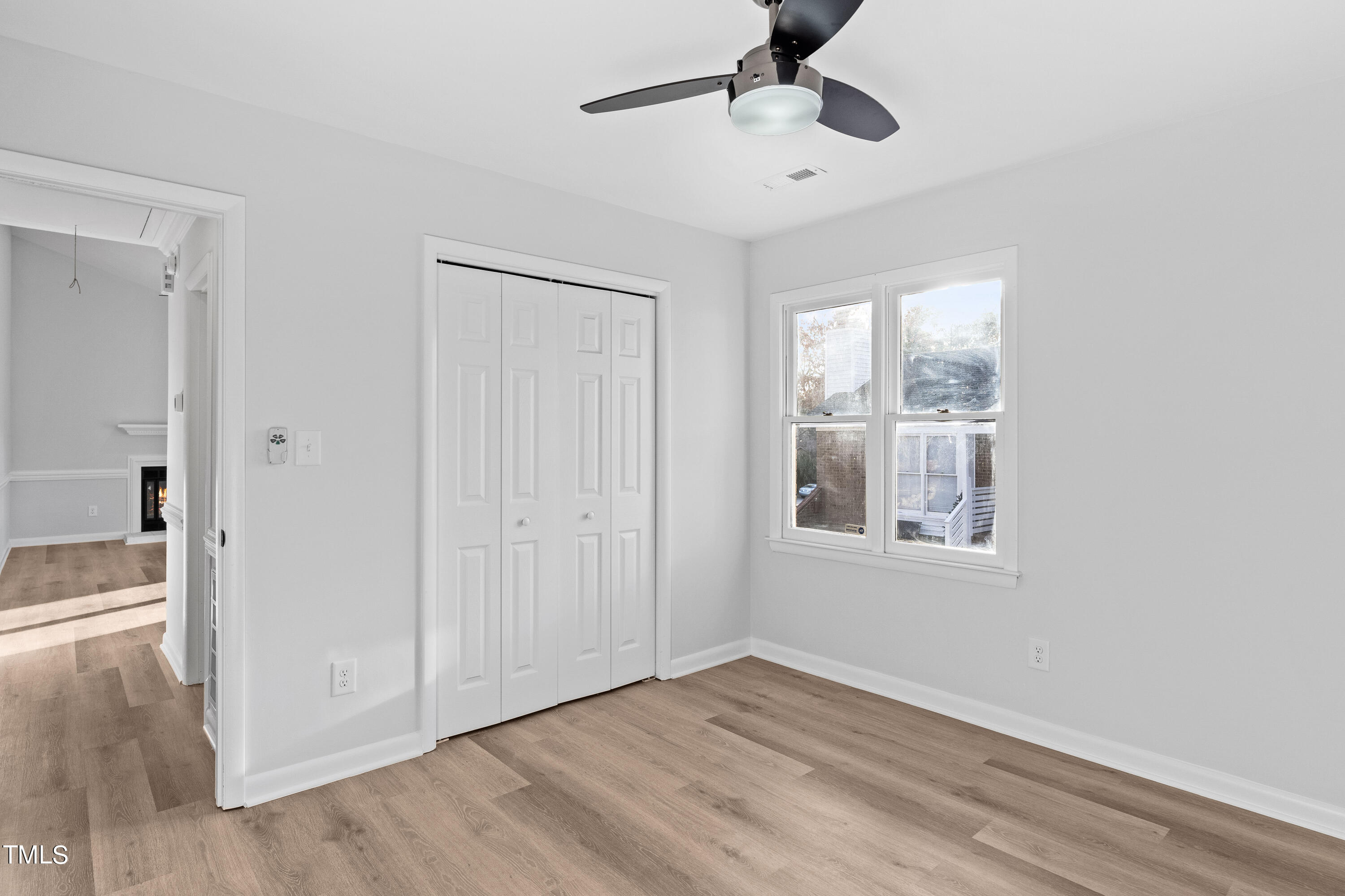4704 Courtside Place Raleigh, NC 27604 - Photo 25 of 33 a view of an empty room with wooden floor and a window