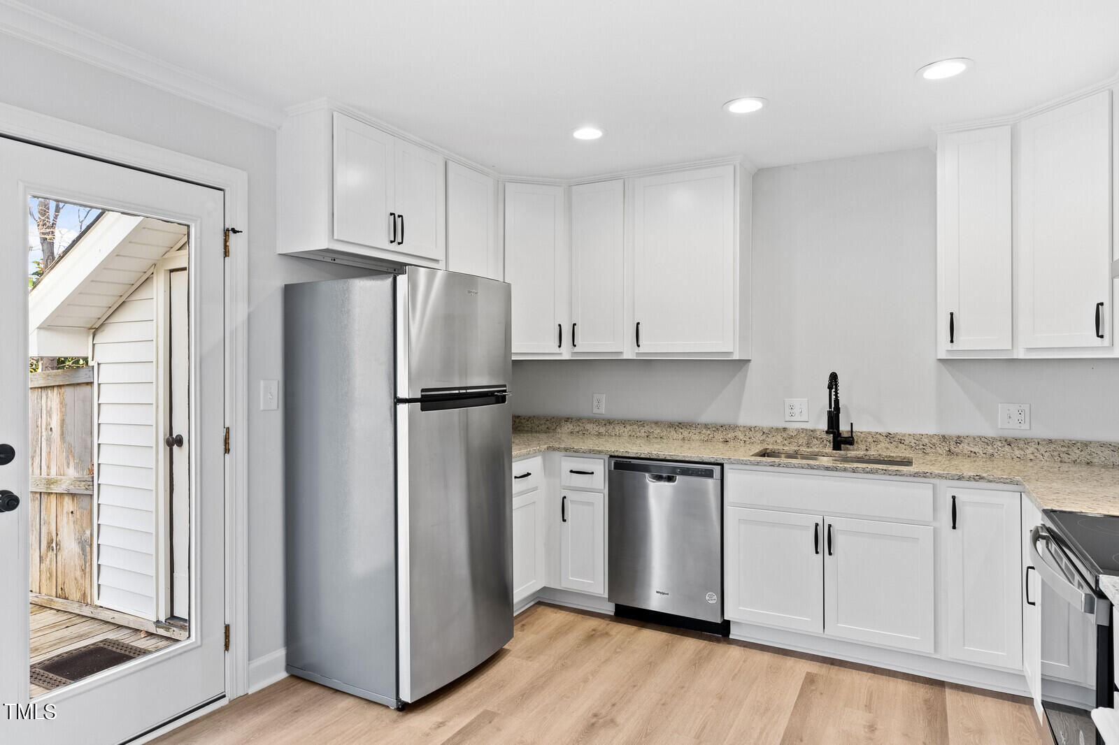 4704 Courtside Place Raleigh, NC 27604 - Photo 7 of 33 a kitchen with stainless steel appliances granite countertop a refrigerator and a stove top oven