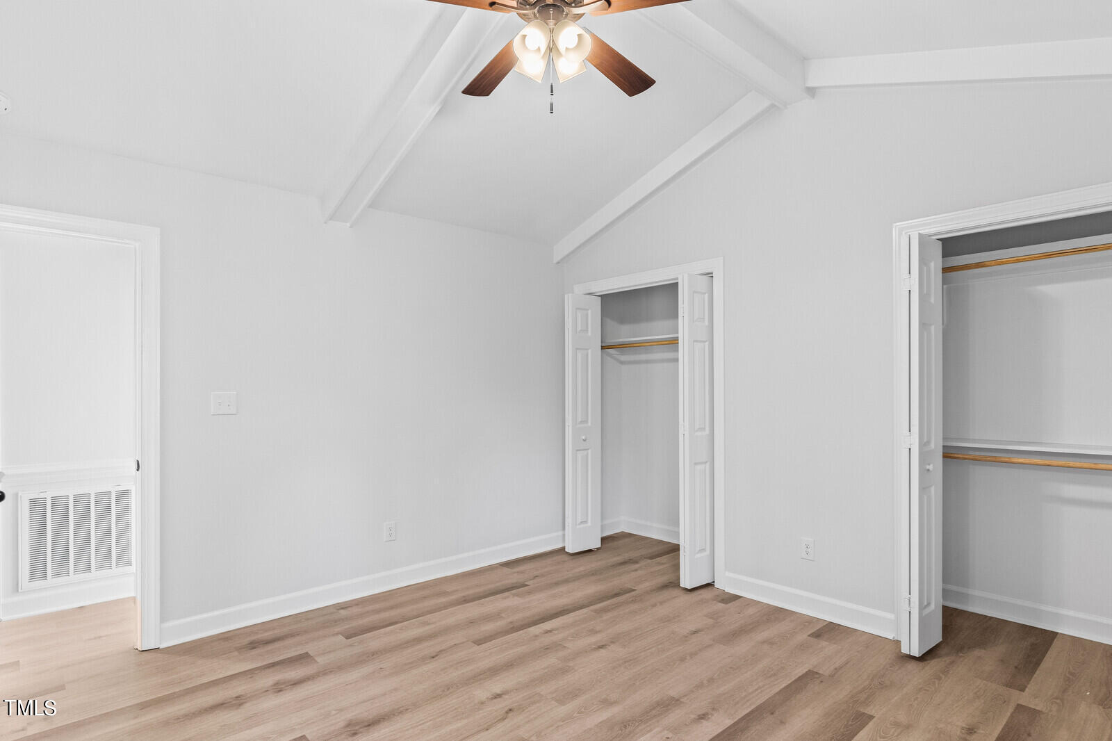 4704 Courtside Place Raleigh, NC 27604 - Photo 9 of 33 an empty room with wooden floor closet and windows