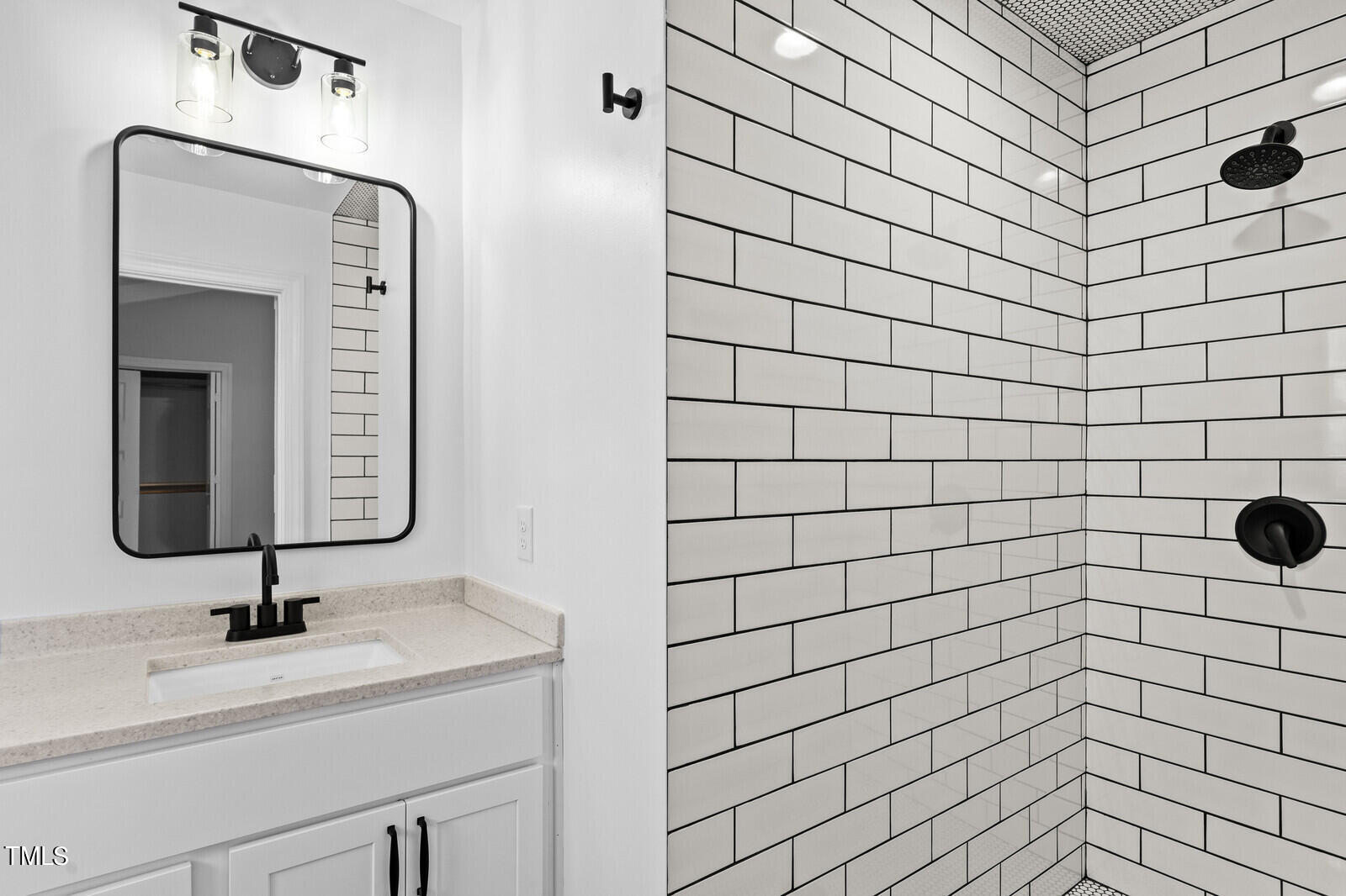 4704 Courtside Place Raleigh, NC 27604 - Photo 10 of 33 a bathroom with a sink and a mirror