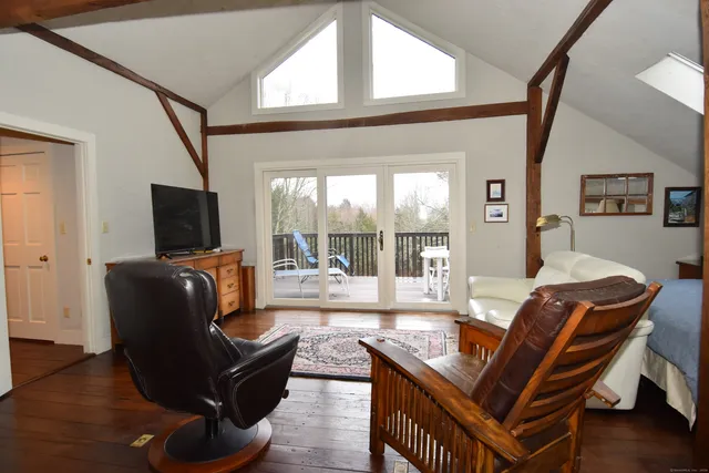 a bedroom with a bed and a mirror