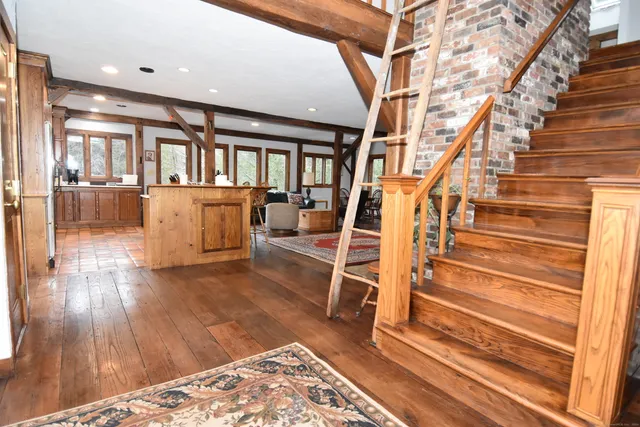 a kitchen with a sink cabinets and wooden floor
