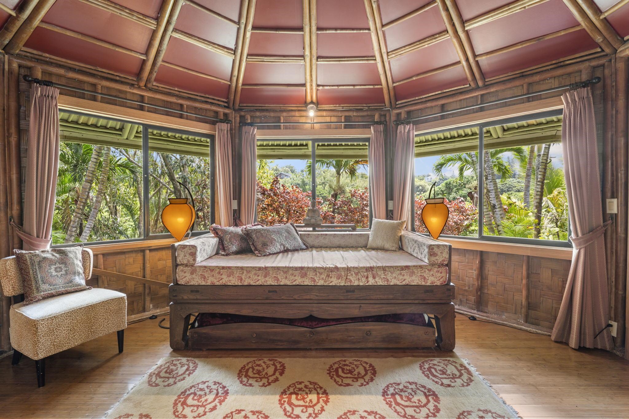 71 Door Of Faith Road Haiku, HI 96708 - Photo 29 of 30 a bedroom with a bed a flat screen tv and a large window with outer view