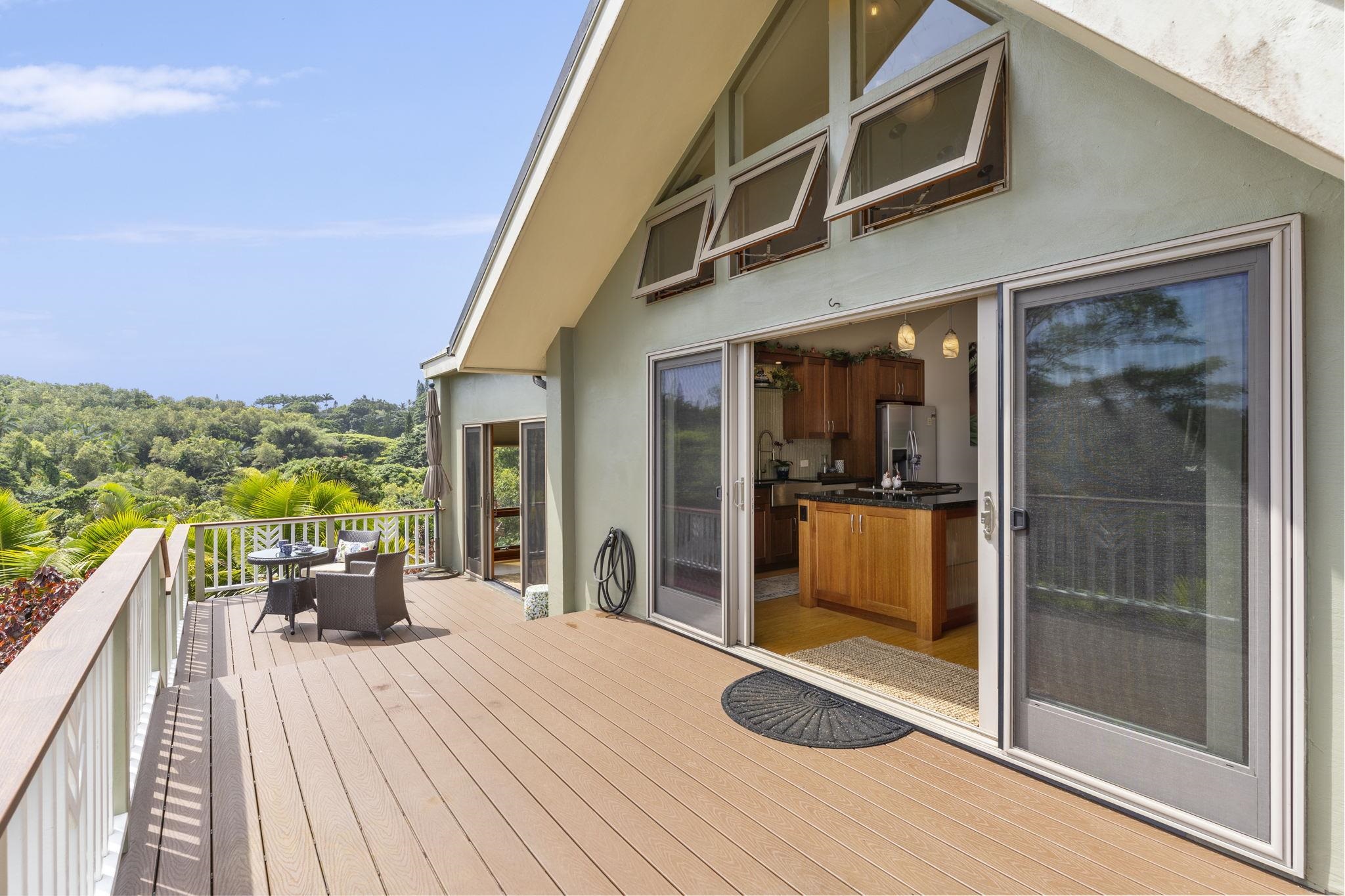 71 Door Of Faith Road Haiku, HI 96708 - Photo 5 of 30 a view of a balcony with chair and wooden floor