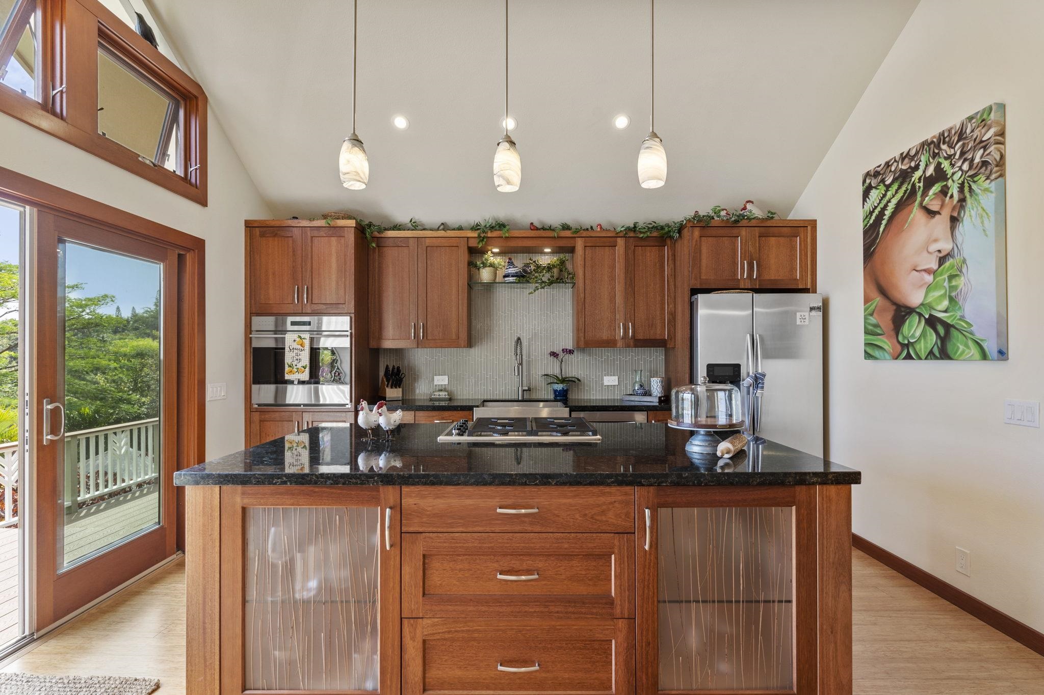 71 Door Of Faith Road Haiku, HI 96708 - Photo 6 of 30 a kitchen with stainless steel appliances granite countertop a refrigerator a sink dishwasher a stove and a dining table with wooden floor