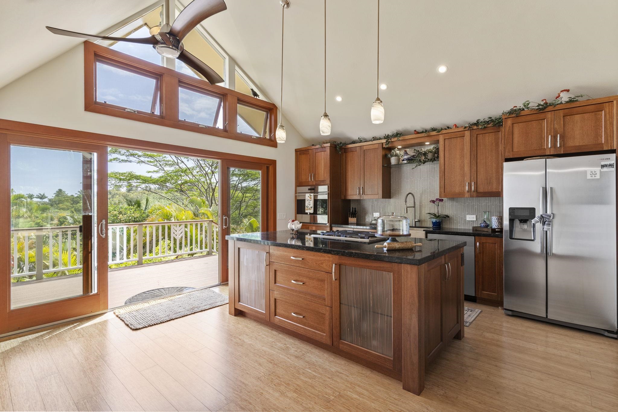 71 Door Of Faith Road Haiku, HI 96708 - Photo 7 of 30 a kitchen with stainless steel appliances granite countertop a refrigerator a sink a stove and a wooden floors