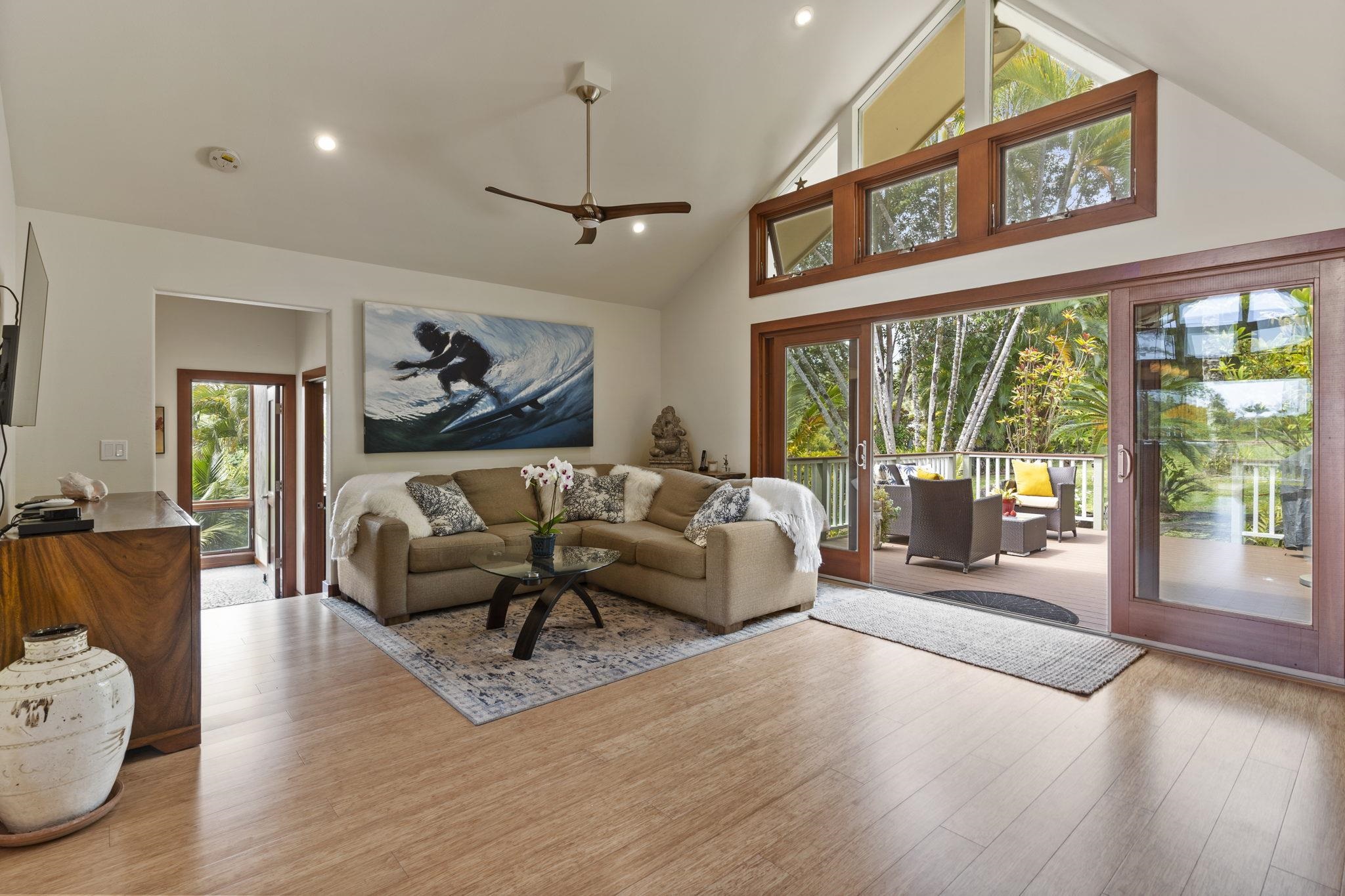 71 Door Of Faith Road Haiku, HI 96708 - Photo 10 of 30 a living room with furniture large window and wooden floor