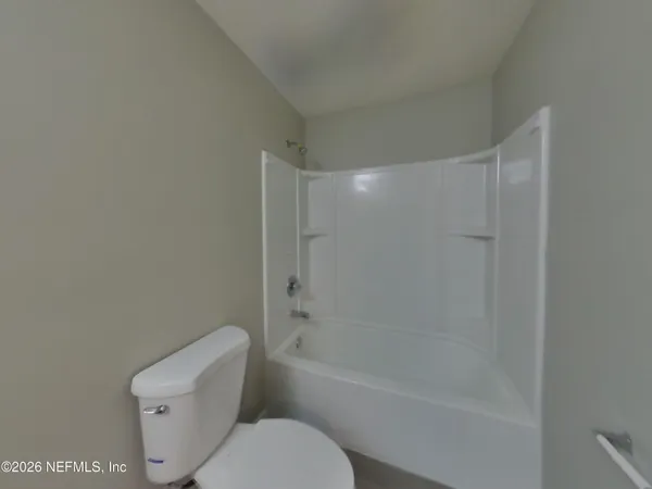 a bathroom with a toilet and a bathtub