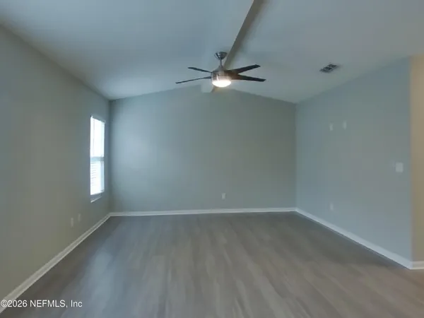 wooden floor in an empty room with a window